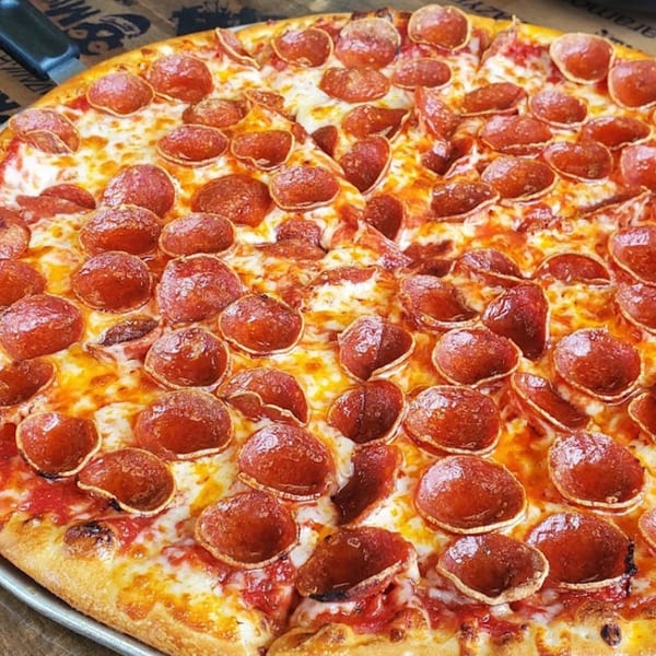 Close-up of a Santino's Pizzeria pepperoni pizza with melted cheese and a crispy crust.